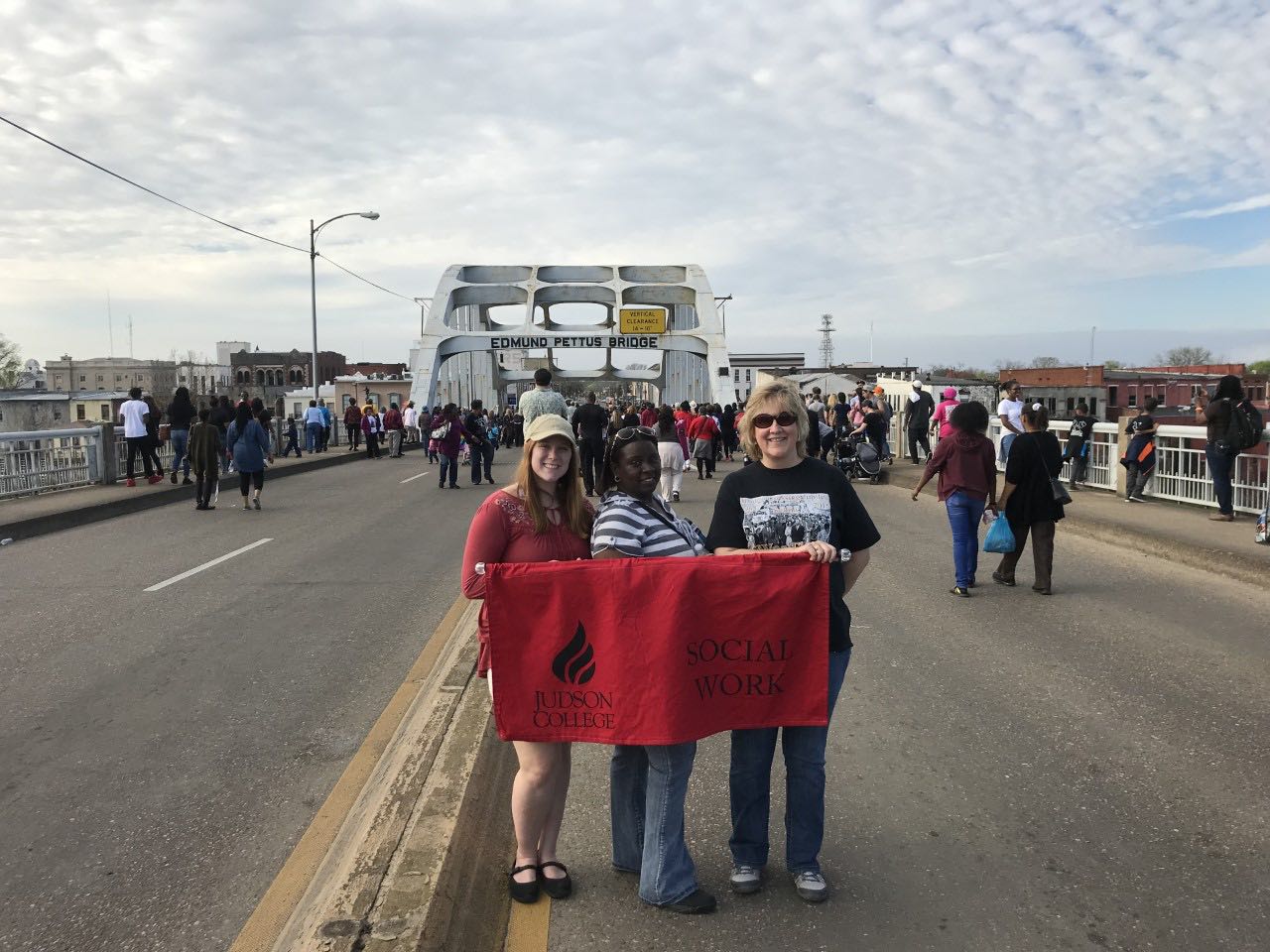 Ms. Dennison and students proudly display the Judson College Social Work Banner as they march over Selma’s historic Edmund Pettus Bridge.